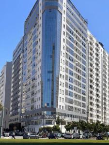 a large building with cars parked in front of it at luxury sea view apartment in Tangier