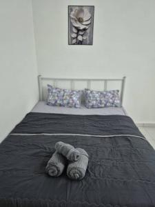 Ένα ή περισσότερα κρεβάτια σε δωμάτιο στο Syaf Homestay