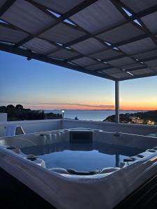 a hot tub on the deck of a boat at Matoc apartments in Murter