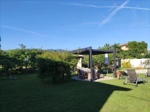 a backyard with a gazebo and chairs on the grass at Ca'Melia Villetta in Sarzana