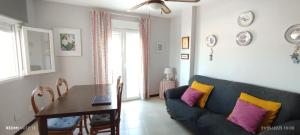 a living room with a couch and a table at salobreña primera linea de playa in Salobreña
