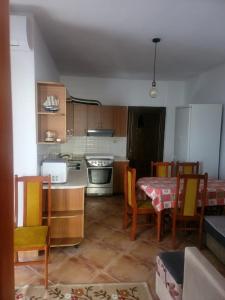 a kitchen with a table and chairs and a kitchen with a refrigerator at Summer apartment! in Durrës +5 photos
