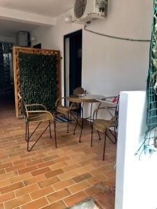 a room with a table and chairs on a brick floor at Apartments Vila San in Kamenari