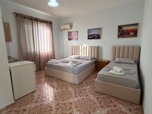 a bedroom with two beds in a room at Vila 23 in Dhërmi