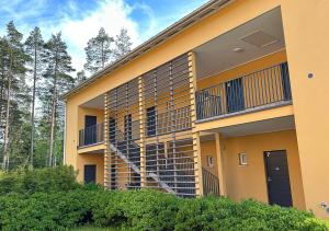 a building with a spiral staircase on the side of it at Kiva Yksiö omalla autopaikalla Bassenkuja Kauklahti Espoo in Espoo +12 photos
