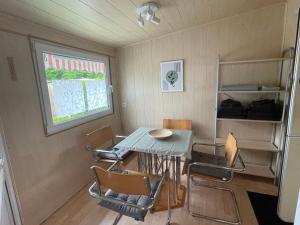 a small dining room with a table and chairs at Campingplatz Wohnwagen mit Vorzelt in Affing