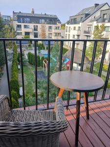a table and chairs on a balcony with a view at Dviejų kambarių butas in Palanga