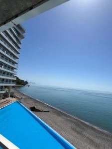 a view of the ocean from the balcony of a building at Bamboo beach in Ts'ikhisdziri