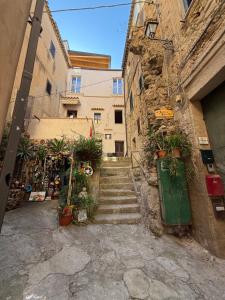an alley with stairs and potted plants in a building at 5 lune Tropea in Tropea