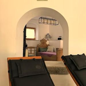 a room with a bedroom with a bed and a chair at Gasthof Zur Post Thurmansbang in Thurmansbang