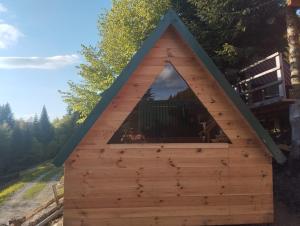 a dog house with a triangular window at Komovi - Kobil Do Guesthouse in Kolašin