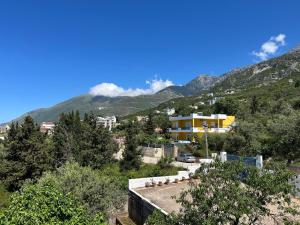 a view of a city with mountains in the background at Vila 23 in Dhërmi