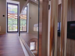 a room with a hallway with a glass door at Stefanos Maisonette in Parga
