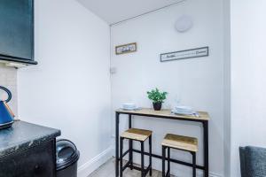 - une petite table dans une cuisine avec deux tabourets dans l'établissement Luxury 1 bedrooom house, sleeps 4, free parking, à Queensbury