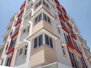 a tall building with red and white at The KONGONI PLACE in Gatunga