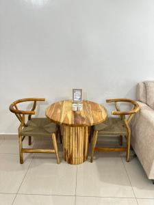 a wooden table with a laptop on it next to a couch at The KONGONI PLACE in Gatunga
