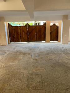 an empty garage with two large wooden gates at The KONGONI PLACE in Gatunga
