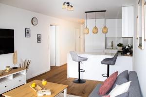 a living room and kitchen with a couch and a table at Flussblick am Töpferberg 2 in Bad Schwartau