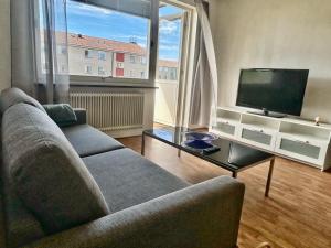 a living room with a couch and a flat screen tv at Två rum & kök Börstorpsgatan 13 B in Töreboda