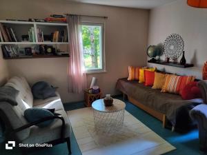 a living room with a couch and a table at Retro House in Savonlinna