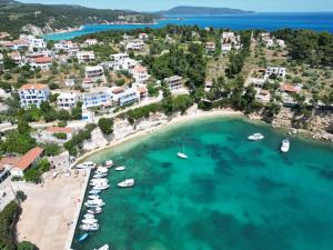 an aerial view of a beach with boats in the water at Magdalini in Votsi