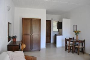 a living room with a table and a dining room at Thalassa Studios in Loutrá Kounoupélli