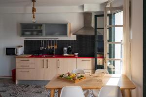 a kitchen with a table with a bowl of fruit on it at Las Vistas Residence - Best Views in Ronda in Ronda