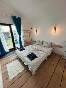 a bedroom with a bed and a large window at Summer Home Corbu in Corbu