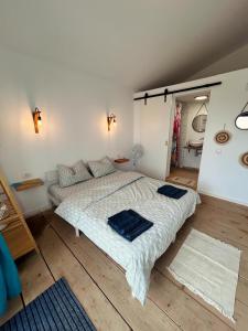 a bedroom with a large bed with blue towels on it at Summer Home Corbu in Corbu