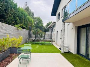 a small garden with a table and a playground at Maison T5 avec piscine T5chambres Annecy in Annecy