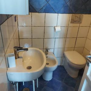 a bathroom with a sink and a toilet at Casa Pappalardo in Ravello +3 photos