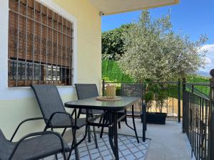 a patio with a table and chairs on a balcony at Andrew's place in Metogjashta