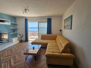 a living room with a couch and a table at Apartment MILA in Senj