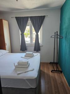 a bedroom with a bed with towels and a window at Apartment MILA in Senj +20 photos