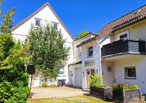 a large white house with a courtyard in front of it at Chalet an der Bode - 2 Zi Fewo zentral am Marktplatz in Braunlage