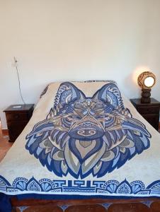a bed with a painting of a wolf on it at Rancho Camote - Frida 1 bedroom in Chichimilá +4 photos