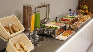 a buffet with many different types of food on a counter at Arbnor Boutique Hotel in Tirana