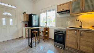 a kitchen with a sink and a stove top oven at Salamina Urban Escape B in Salamina