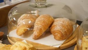 a glass plate with croissants on a table at Arbnor Boutique Hotel in Tirana +33 photos