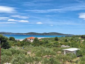a view of a body of water with houses and trees at Apartments and Rooms Saric in Jadrija