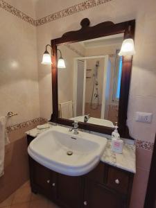 a bathroom with a sink and a large mirror at Etna view Villa Letizia a Taormina in Taormina +87 photos