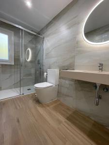 a bathroom with a toilet and a sink and a shower at Sunset Palm in El Puerto de Santa María
