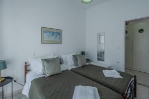 a bedroom with a bed and a table at STEGNA REA Seaside Apartment in Archangelos