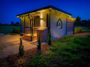 a small building with a light on the front at A2 House in Kolkja