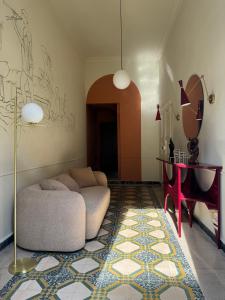 a living room with a couch and a table at Academia Apulian Suites - Marsia's Apartment in Mola di Bari