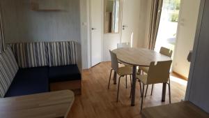 a small living room with a table and chairs at Camping de la minière in Forges-les-Eaux +22 photos
