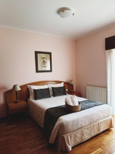 a bedroom with a large bed with a basket on it at Casa Machado in Montalegre +30 photos