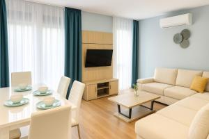 a living room with a table and a couch at Biser Igala in Herceg-Novi