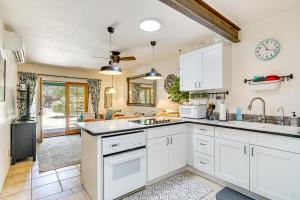 a kitchen with white cabinets and a sink at Vibrant Casa Paloma with Patio - Near Vineyards! in Patagonia +22 photos