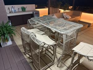 a metal table and chairs on a patio at Biser Igala in Herceg-Novi